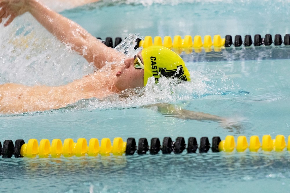 Swimmer in a pool with a green swim cap