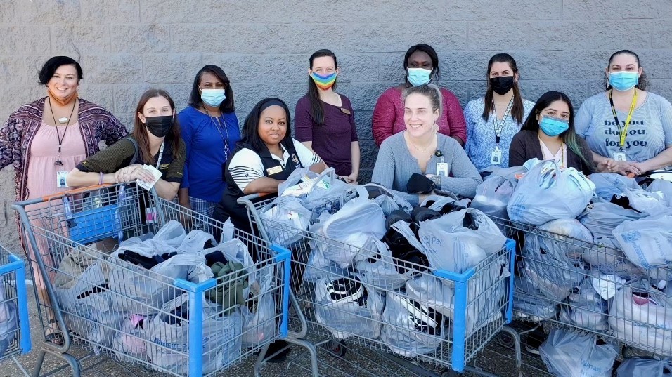 People standing behind shopping baskets