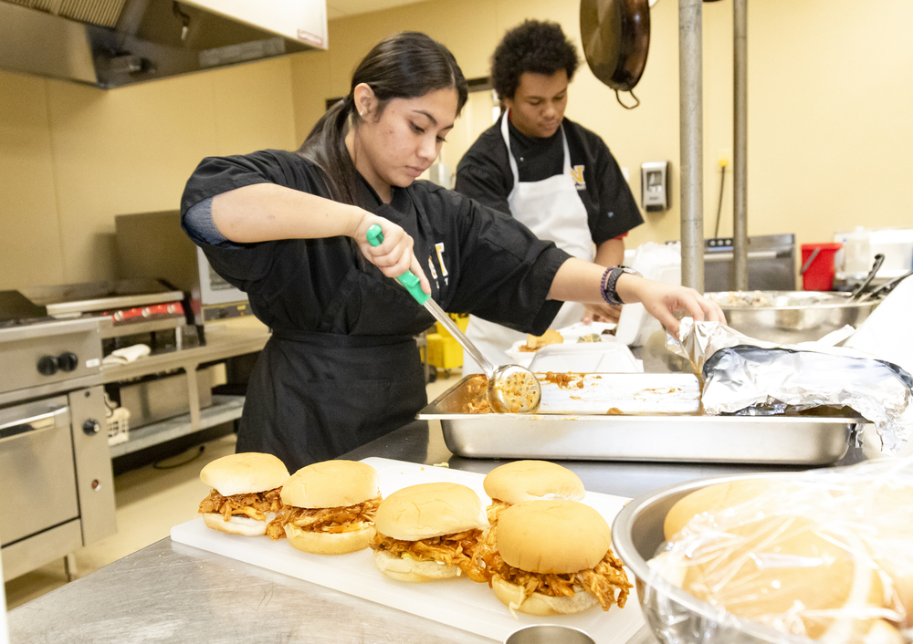 Students prep sandwiches for Dragon Coffee Bar and Bistro